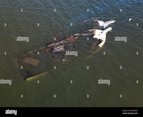 Aerial view looking straight down from above at capsized boats that ...