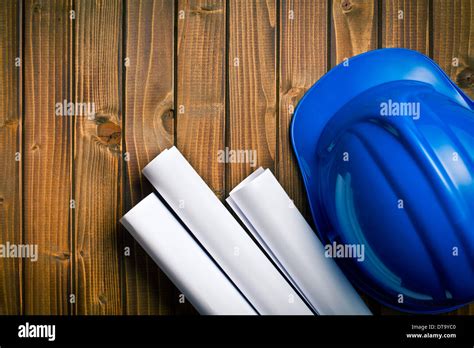 hard hat with drawings on wooden background Stock Photo - Alamy