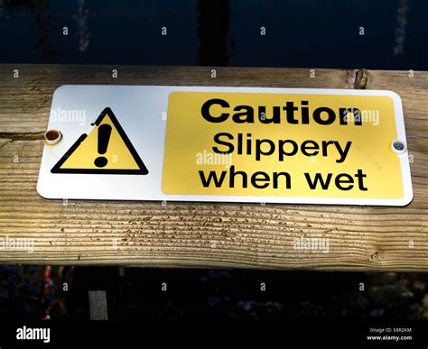 Caution slippery when wet sign Stock Photo - Alamy
