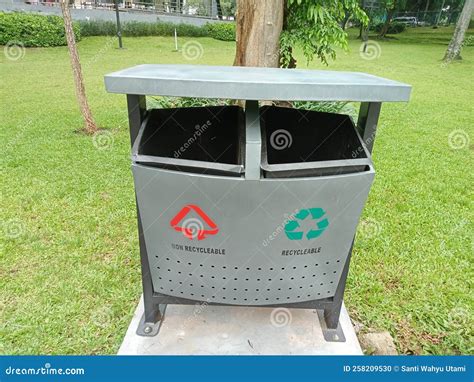 Trash can in the park stock photo. Image of environment - 258209530