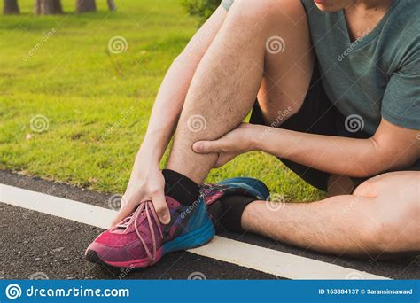 Ankle Sprained. Young Man Suffering From An Ankle Injury While Running ...