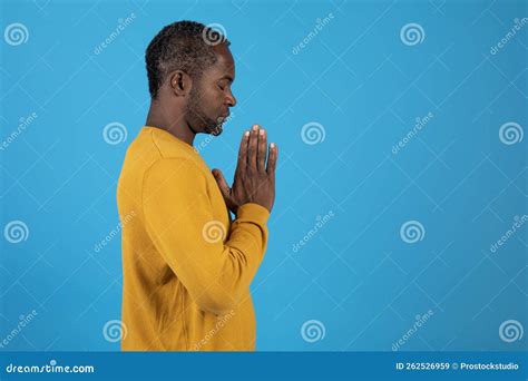 Black Man Praying with Closed Eyes on Blue, Side View Stock Image ...
