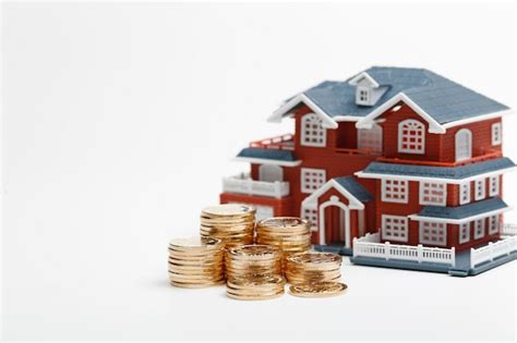 Rmb coins stacked in front of the housing model (house prices, house ...