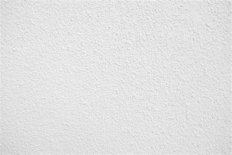 Textura sem costura da parede de cimento branco uma superfície áspera ...