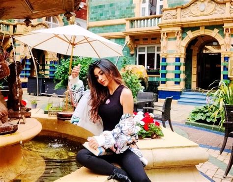 Mouni Roy Poses Near The Fountain in All Black Dress, Floral Jacket And ...