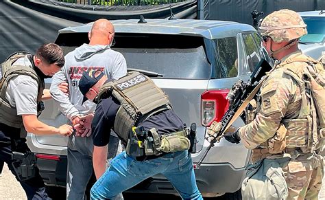 Photos show National Guard with rifles on ICE enforcement missions - ABC News