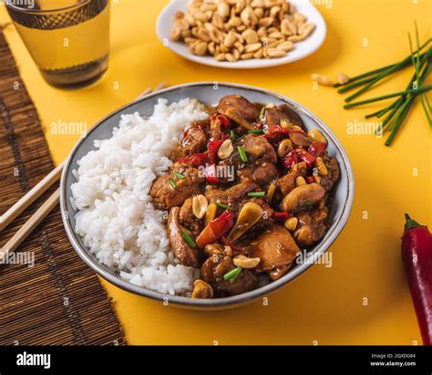 From above composition bowl with kung pao chicken with white rice ...