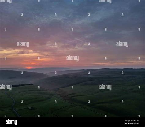 The vibrant colors of the sunset sky paint a dramatic backdrop over the ...