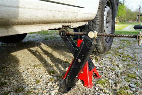 Car lifted on jack. Mechanic lifting up the car with car jack. Tire ...