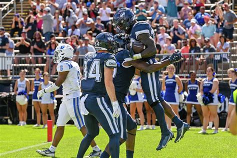 UConn football team celebrates at Rentschler after imperfect victory ...