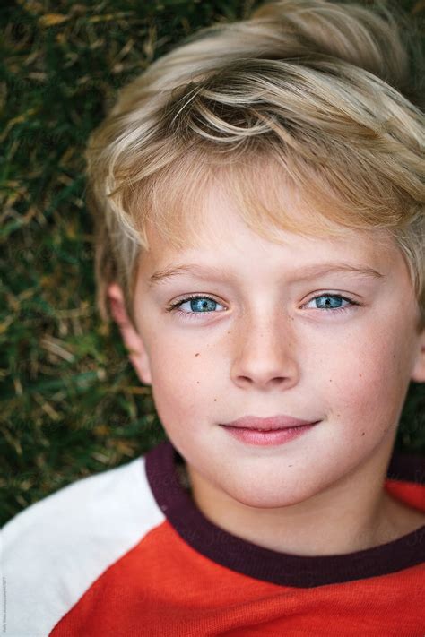 "Close-up, Overhead Portrait Of A Boy Lying In The Grass" by Stocksy ...