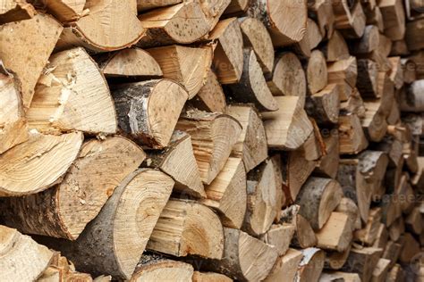 firewood stacked in the woodpile, textured firewood background of ...