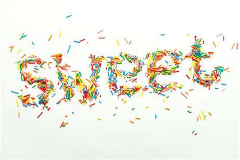 Premium Photo | Colorful word sweet written with sugar sprinkles