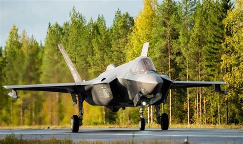 Royal Air Force ground crew preparing an RAF Typhoon fighter jet. It is night-time and the team are