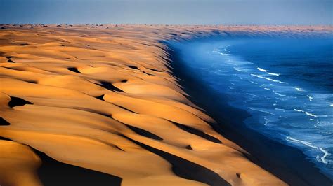 Dunes of the Namib Desert meet the Atlantic Ocean, Namibia, Africa ...