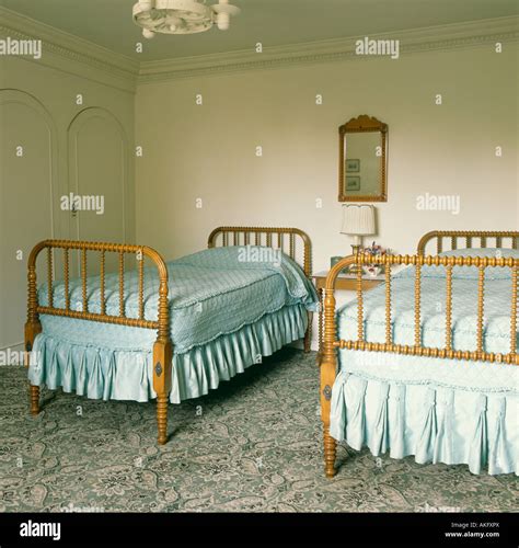 Spindle balusters on antique wooden twin beds in traditional bedroom ...