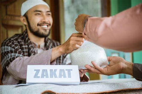 Man giving a rice as a food donation for zakat during eid mubarak ...
