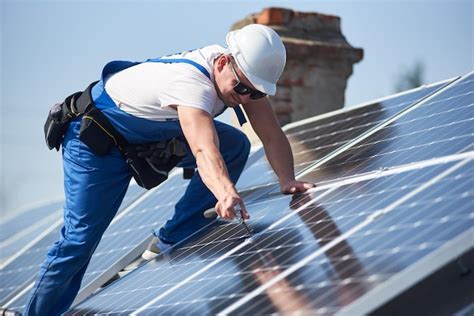 Installing solar photovoltaic panel system on roof of house | Premium Photo