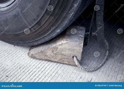 Wooden wheel stopper. stock image. Image of tire, logistics - 94634769