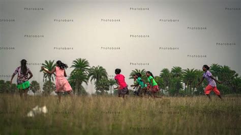 Children Playing Football in a Rural Field