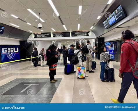 People Waiting for a Train Being Transported To an Airport Gate at the ...