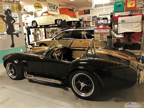 Modern garage with car lift, neon sign, and tool storage - Bob from TN