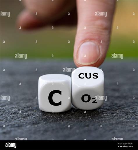 Symbol for carbon capture, utilization and storage (CCUS). Hand turns dice and changes the ... - symbol for carbon