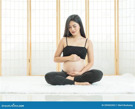 A Beautiful Pregnant Woman Sitting in Japanese Room To Catch Her ...