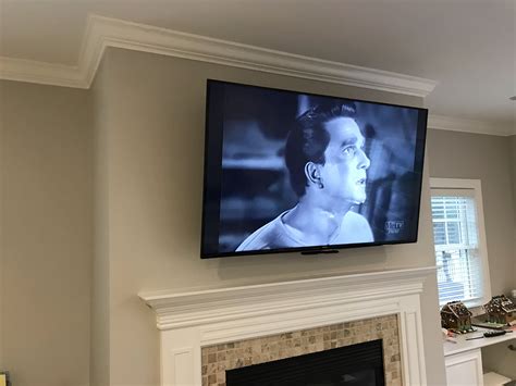 Curved TV Mounted Over Fireplace | TV Wall Mount Ideas