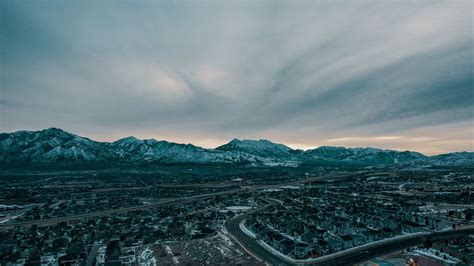 Download wallpaper 2560x1440 mountains, aerial view, village, snowy ...
