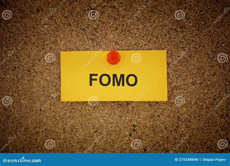 A Yellow Paper Note with the Acronym FOMO (fear of Missing Out) on it ...