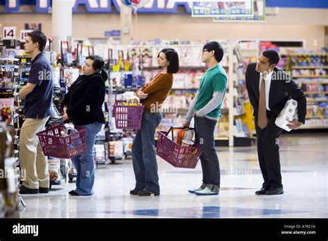 People stand in lines at an Upper East Side grocery store in New York.