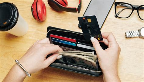 Backpacker comparing backup travel funds including cash and credit cards