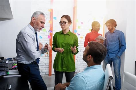 Group of People Standing in Office Pointing 的图像结果
