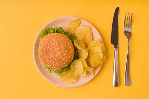 Top view burger and chips with cutlery | Free Photo
