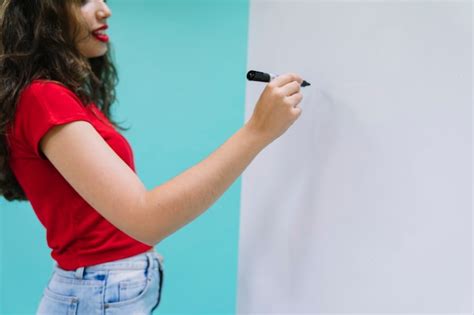 Young woman writing on the whiteboard | Free Photo