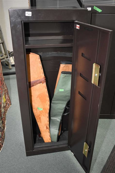 Floor standing single door brown coloured floor safe and three soft gun ...