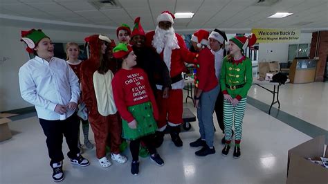 Scofield Magnet Middle School student elves fill boxes for homeless shelter
