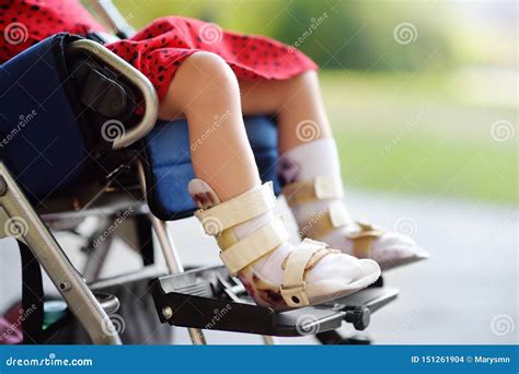 Disabled Girl Sitting in Wheelchair. on Her Legs Orthosis. Child Cerebral Palsy Stock Photo ...