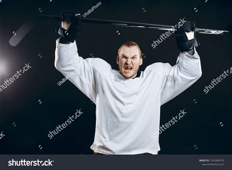 Portrait of cheerful handsome hockey player getting into the mood for ...
