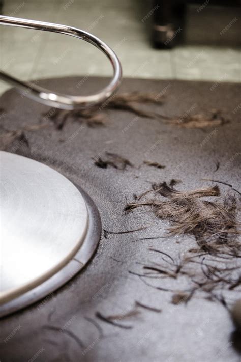 Premium Photo | Chair closeup with hairs on the floor