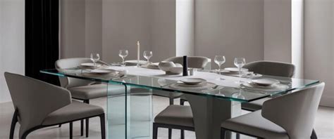 An elegant modern dining set featuring a clean glass table and stylish ...