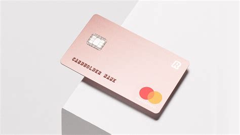a pink credit card sitting on top of a white surface
