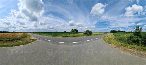Beautiful high resolution panorama of a northern european country road with fields and green ...