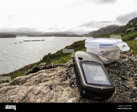 geocaching in scotland with gps device and cache container Stock Photo ...