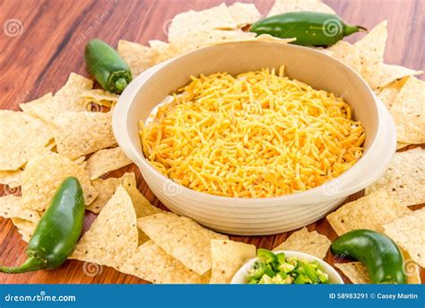 Preparation of Bean Dip with Jalapenos, Sour Cream and Cheddar C Stock ...