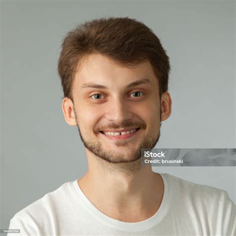 Studio Portrait Of A 27 Year Old Man With A Beard In A White Tshirt On ...