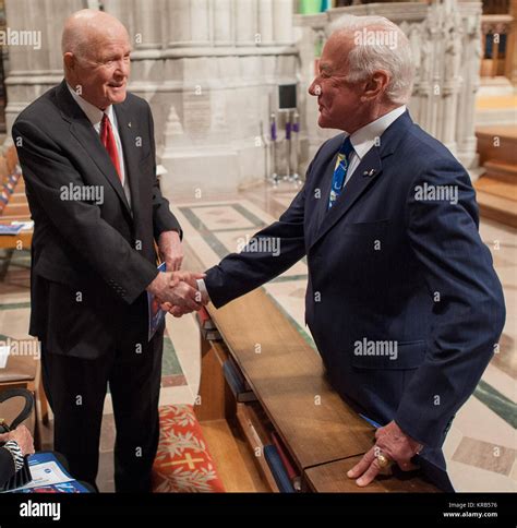 Former U.S. Sen. John Glenn, left, and Buzz Aldrin shake hands prior to a memorial service ...