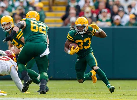 Download Aaron Jones of the Green Bay Packers running the ball down the ...