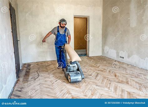 Carpenter Grinding a Wooden Parquet Floor by Using Floor Sander Machine ...